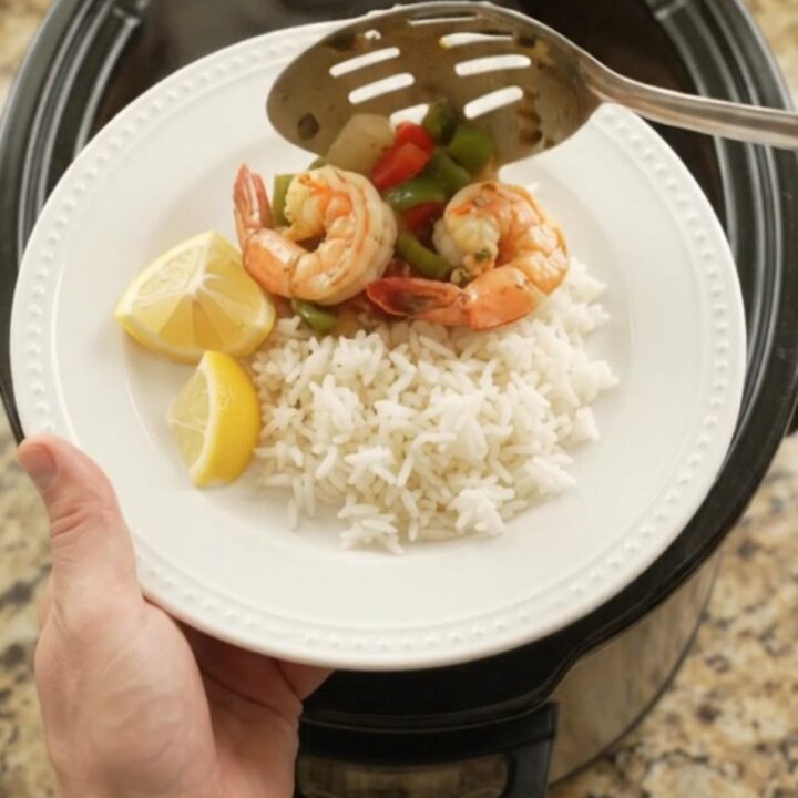 Slow cooker chili lime butter jumbo shrimp with bell peppers and onions in a glossy butter sauce.
