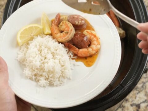 Snow crab, shrimp, and andouille sausage in a slow cooker with spiced butter sauce