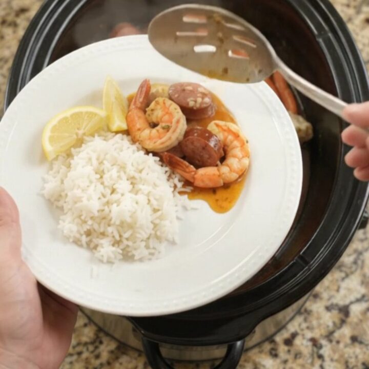 Snow crab, shrimp, and andouille sausage in a slow cooker with spiced butter sauce