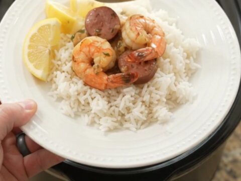 Slow cooker filled with snow crab, shrimp, and sausage in chili-lime butter