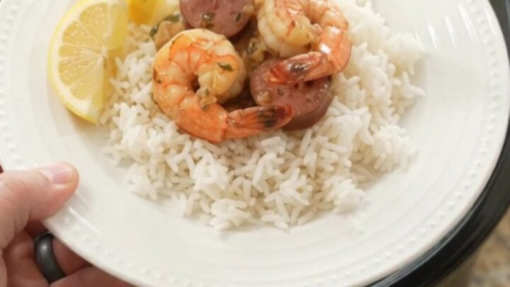 Slow cooker filled with snow crab, shrimp, and sausage in chili-lime butter