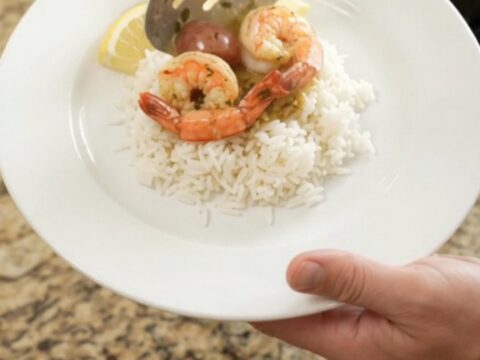 Crockpot herb butter cajun boil with lobster tails, shrimp, corn, and potatoes in a slow cooker.