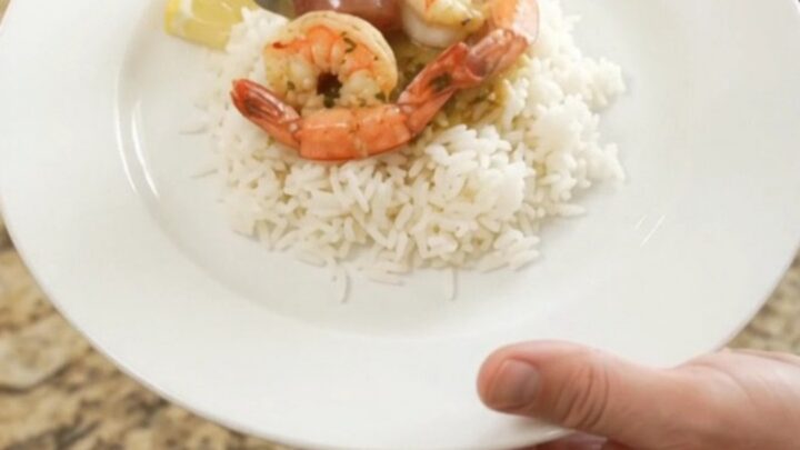 Crockpot herb butter cajun boil with lobster tails, shrimp, corn, and potatoes in a slow cooker.