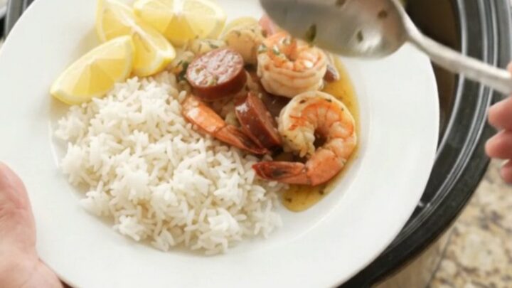 Slow cooker seafood boil with lobster tails, shrimp, sausage, and potatoes in a buttery Old Bay sauce