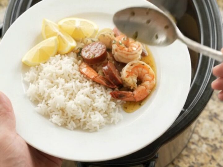 Slow cooker seafood boil with lobster tails, shrimp, sausage, and potatoes in a buttery Old Bay sauce