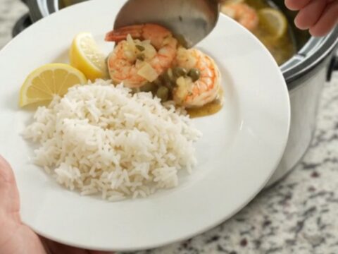Slow cooker lobster tails and shrimp in golden Old Bay butter with lemon slices and capers