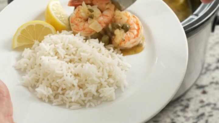 Slow cooker lobster tails and shrimp in golden Old Bay butter with lemon slices and capers