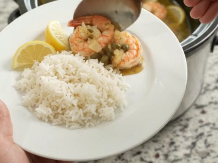 Slow cooker lobster tails and shrimp in golden Old Bay butter with lemon slices and capers