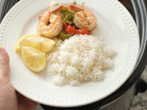 Crockpot with herb butter lobster tails and shrimp in a golden sauce