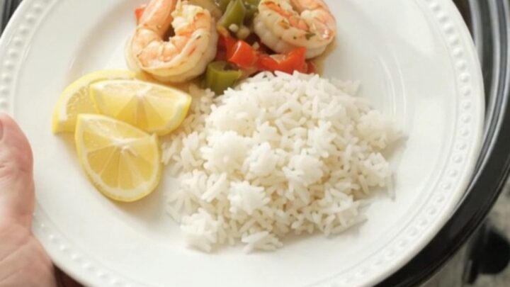 Crockpot with herb butter lobster tails and shrimp in a golden sauce