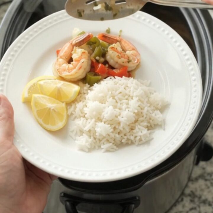 Crockpot with herb butter lobster tails and shrimp in a golden sauce