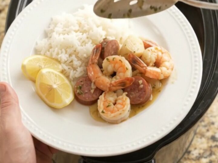 Slow cooker seafood boil with scallops, shrimp, and sausage in a buttery Old Bay sauce.