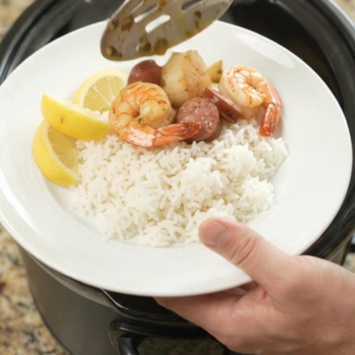 Slow cooker seafood boil with scallops, shrimp, Andouille, and potatoes in a chili-lime butter sauce