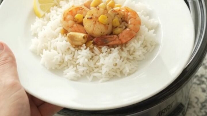 Crockpot with bayou butter garlic corn sea scallops, bubbling in crimson sauce