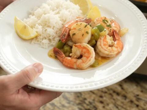 Slow cooker chili lime butter sea scallops and shrimp with bell peppers and onions, glistening in a glossy sauce.