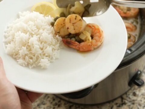 Slow cooker chili lime butter sea scallops and shrimp with lemon and capers in a glossy sauce.
