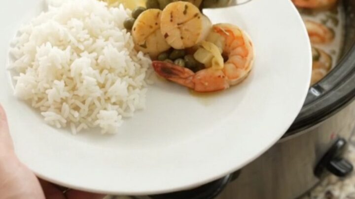 Slow cooker chili lime butter sea scallops and shrimp with lemon and capers in a glossy sauce.