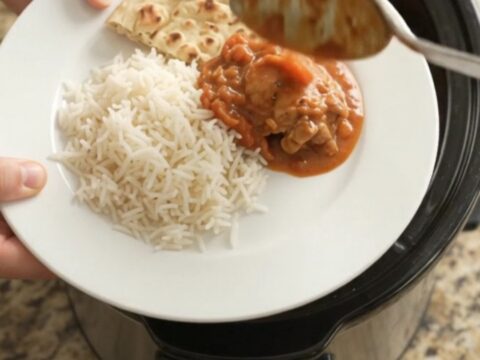 Slow cooker tikka masala chicken thighs in creamy coconut sauce with cilantro