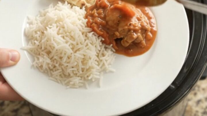Slow cooker tikka masala chicken thighs in creamy coconut sauce with cilantro