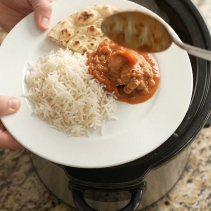 Slow cooker tikka masala chicken thighs in creamy coconut sauce with cilantro