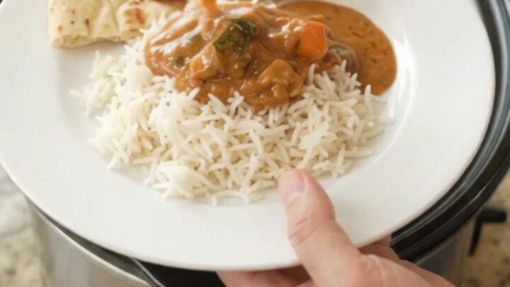 Slow cooker creamy ghee red curry chicken thighs with peppers in a glossy sauce