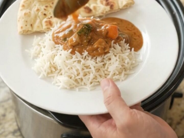 Slow cooker creamy ghee red curry chicken thighs with peppers in a glossy sauce
