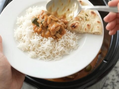 Slow cooker Thai red curry with chicken thighs, peppers, and bamboo shoots in a rich coconut cream sauce
