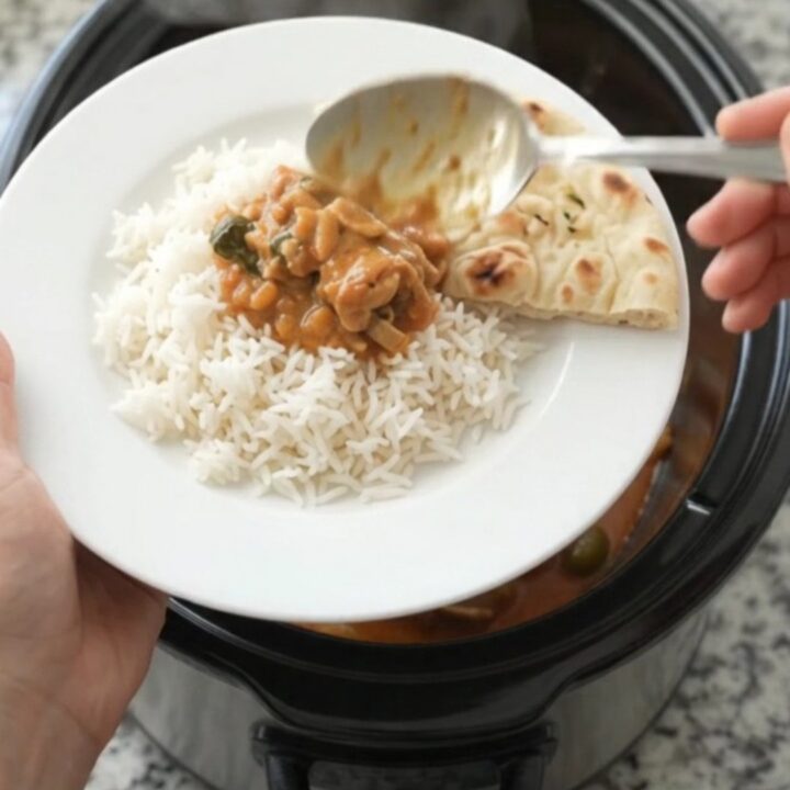 Slow cooker Thai red curry with chicken thighs, peppers, and bamboo shoots in a rich coconut cream sauce