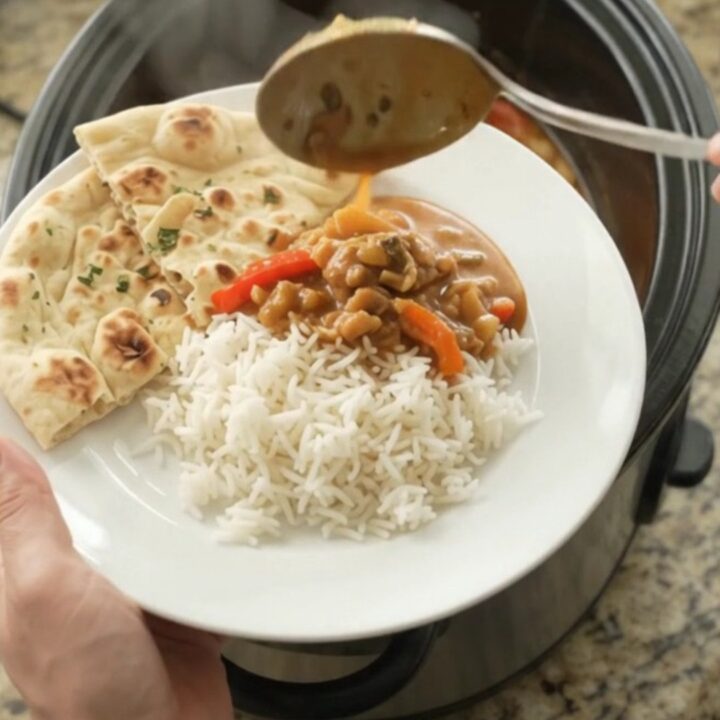 Slow cooker garlic butter red curry chicken thighs with peppers and bamboo shoots