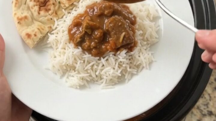 Bubbling slow cooker lamb tikka masala with coconut cream and cilantro