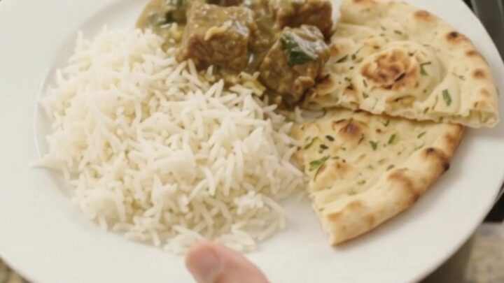 Slow cooker lamb saag with creamy spinach sauce and tender lamb cubes in a black crockpot
