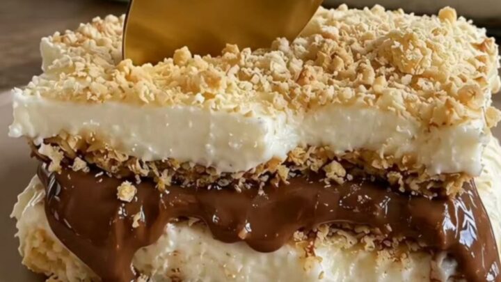 A slice of decadent Nutella coffee icebox cake on a ceramic dish with a gold spoon.