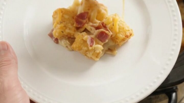 Golden tater tot bake with melted cheddar and bacon in a slow cooker