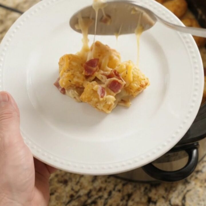 Golden tater tot bake with melted cheddar and bacon in a slow cooker