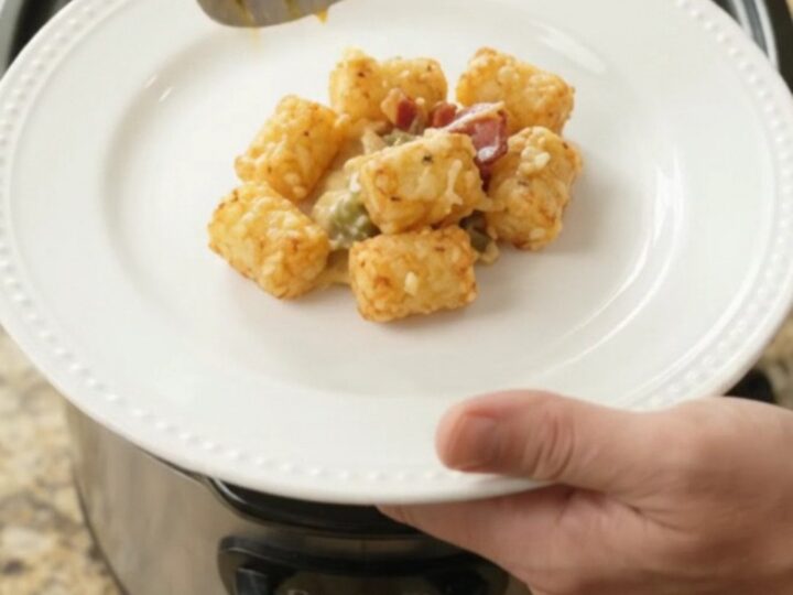Crockpot filled with bubbling smoked Gouda green chile tater tot bake, golden and cheesy