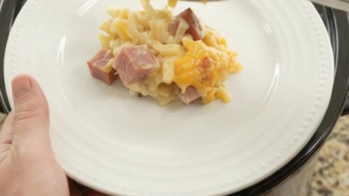 Crockpot cheddar sour cream hashbrown bake with melted cheese and ham