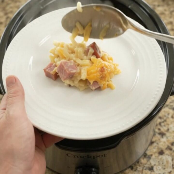 Crockpot cheddar sour cream hashbrown bake with melted cheese and ham