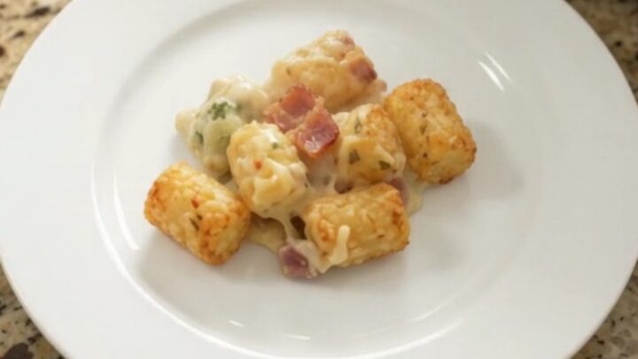 Crockpot tater tot casserole with broccoli and pepper jack cheese, golden and bubbling in the slow cooker.