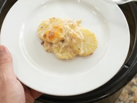 Crockpot smoked gouda sour cream scalloped potatoes with melted cheese on top