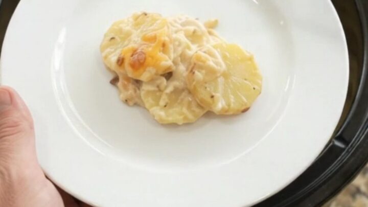 Crockpot smoked gouda sour cream scalloped potatoes with melted cheese on top