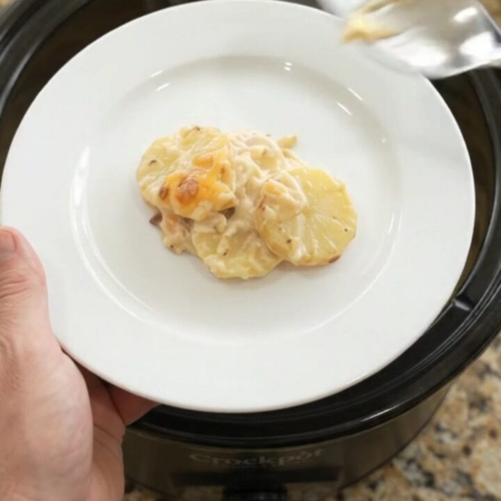 Crockpot smoked gouda sour cream scalloped potatoes with melted cheese on top