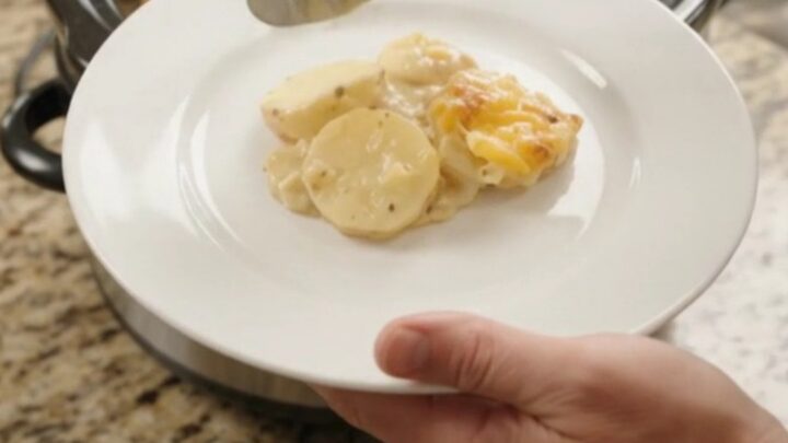 Golden cheddar crust over creamy scalloped potatoes in a slow cooker