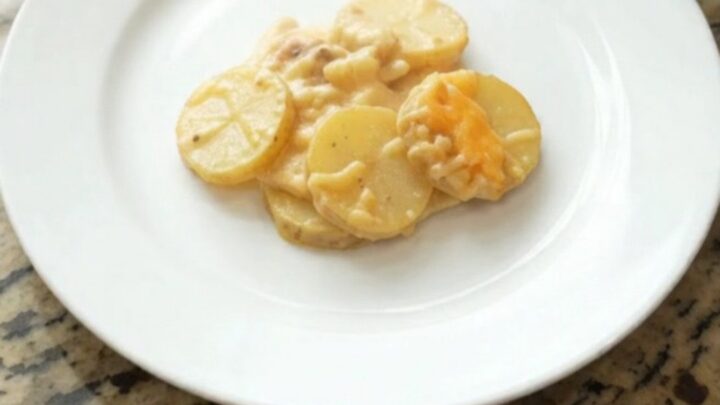 Slow cooker filled with bubbling smoked gouda scalloped potatoes