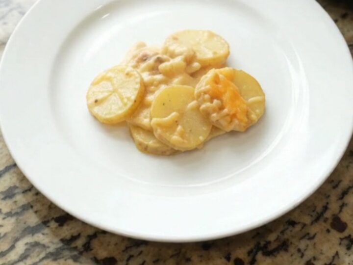 Slow cooker filled with bubbling smoked gouda scalloped potatoes