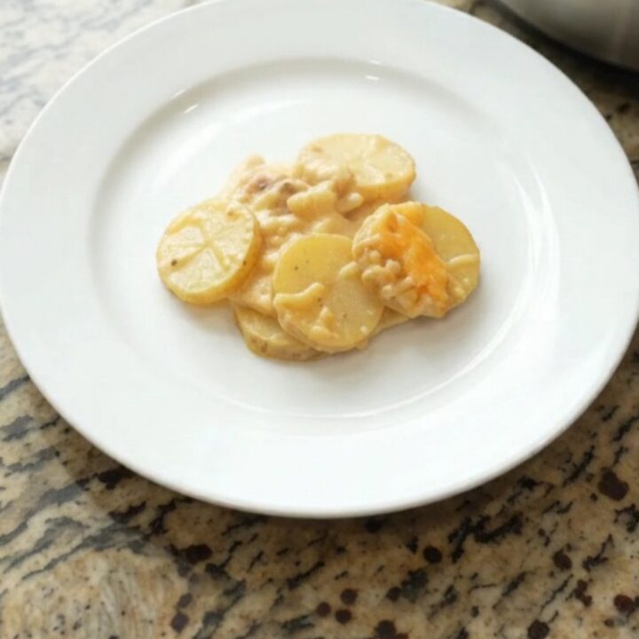 Slow cooker filled with bubbling smoked gouda scalloped potatoes