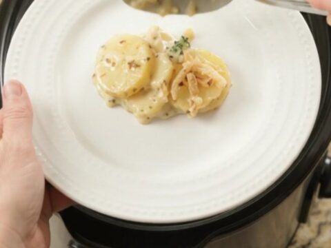 Creamy Crockpot scalloped potatoes with broccoli and melted pepper jack cheese, topped with crispy onions.