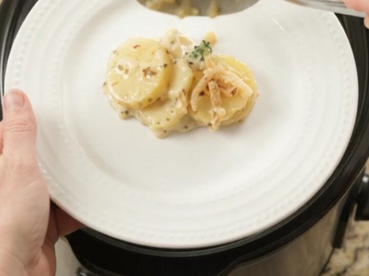Creamy Crockpot scalloped potatoes with broccoli and melted pepper jack cheese, topped with crispy onions.