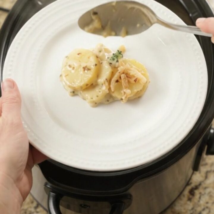 Creamy Crockpot scalloped potatoes with broccoli and melted pepper jack cheese, topped with crispy onions.