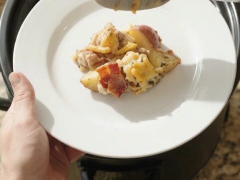 Bubbling Crockpot pepper jack ranch potato bake with melted cheese and crispy onions