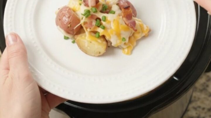 Bubbling slow cooker full of cheesy red potatoes and bacon